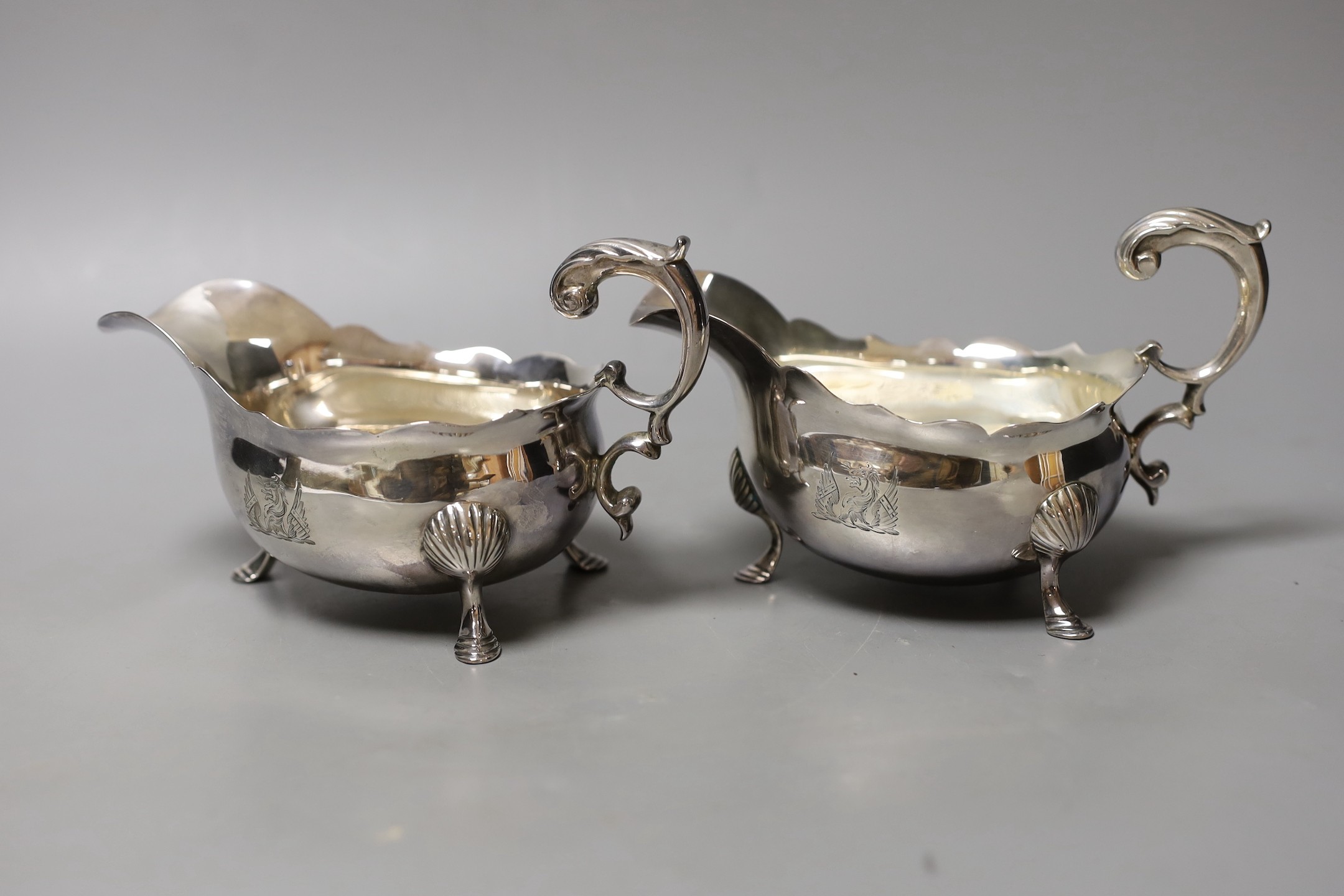 A pair of Georgian silver sauceboats, with flying scroll handles, marks rubbed, length 17cm